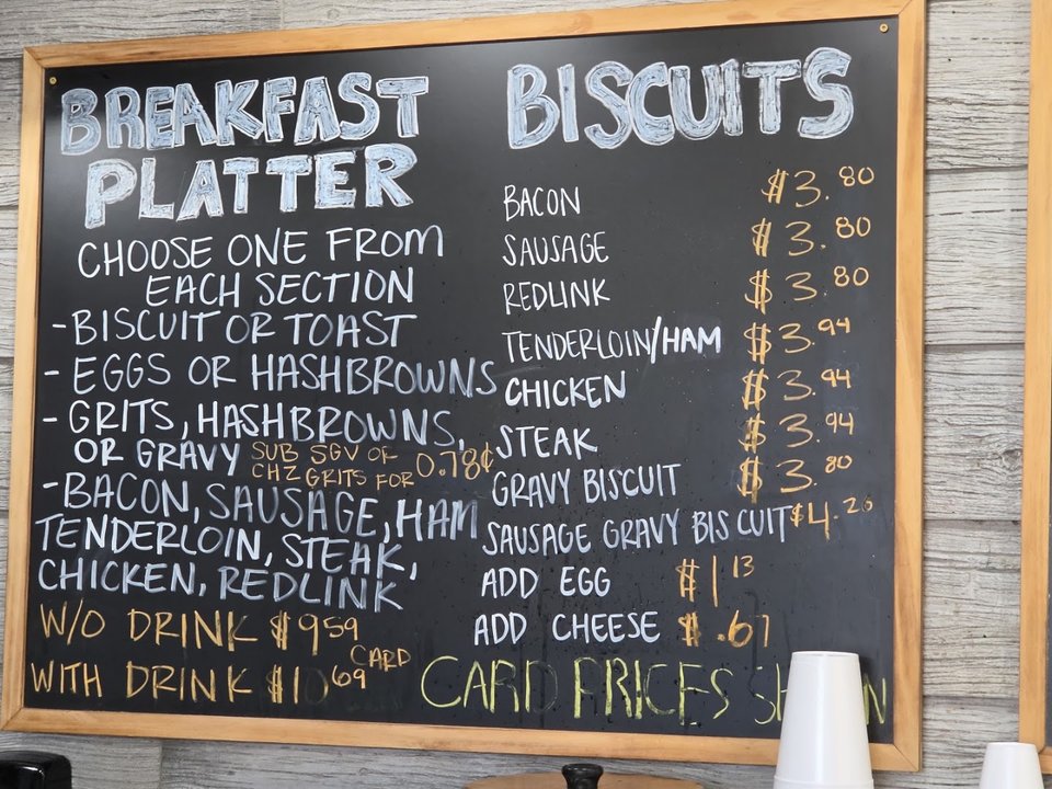 Coffee cups beside biscuits and hearty lunch dishes.